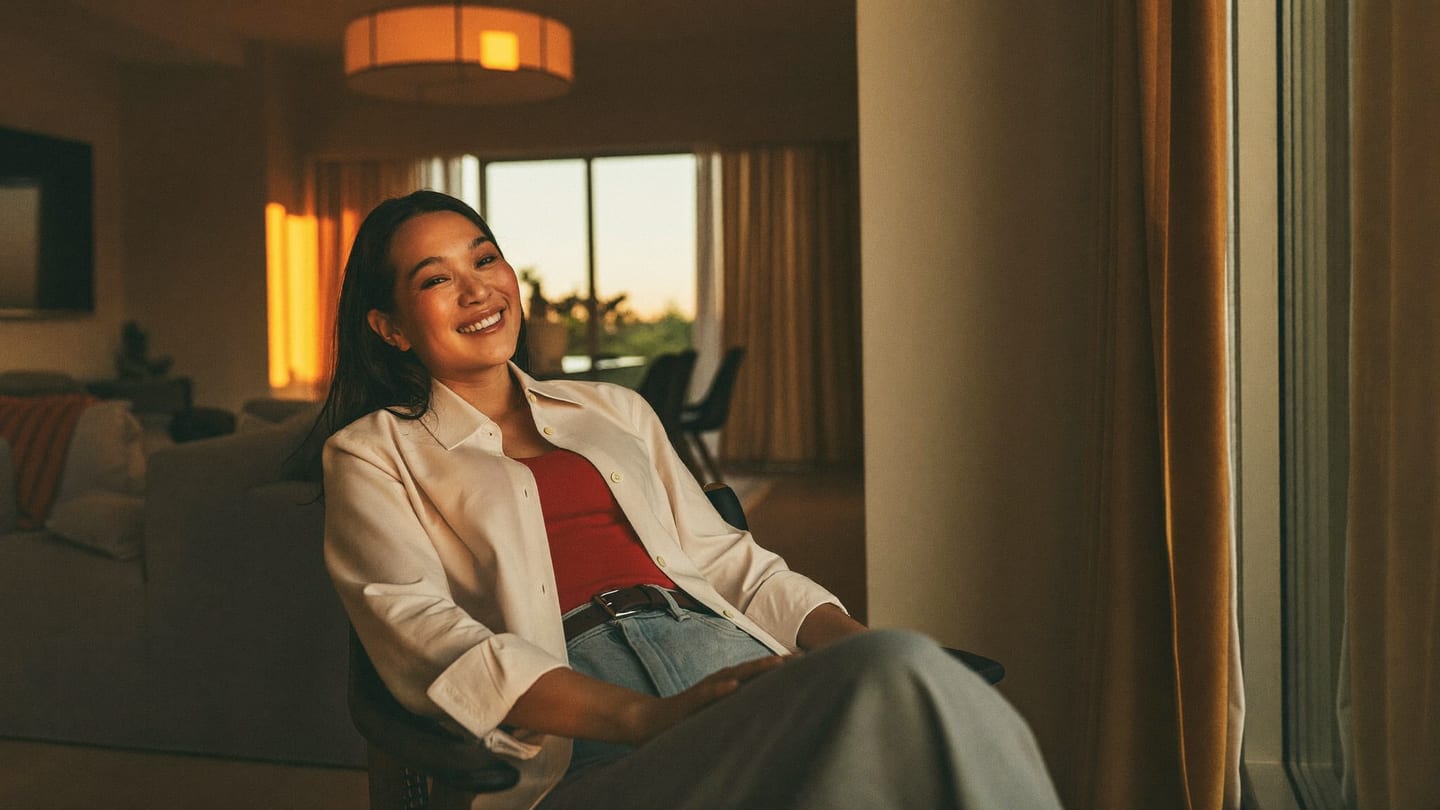 A confident professional relaxing at home in warm evening light