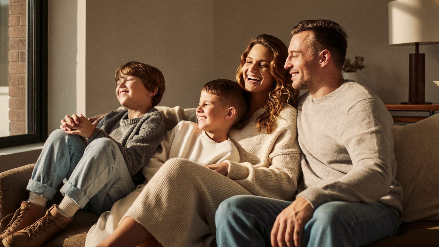 Two parents and their young children together at home