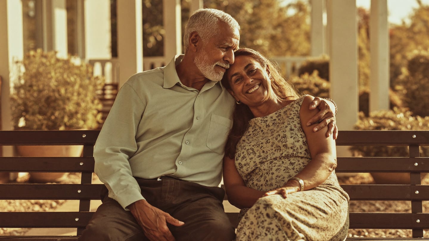 A retired couple relaxing together at golden hour